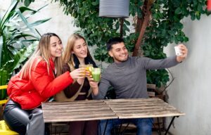 A group of four millenial friends making faces for a selfie