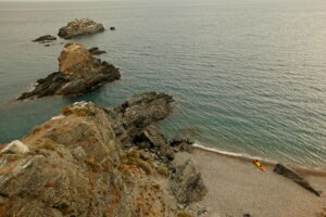 Beautiful seashore with people hiking over the rocks in Spain, Almunecar, cliff San Cristobal