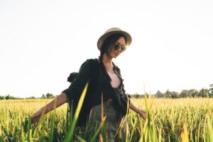 Carefree female tourist enjoying summertime spending at rural environment exploring beautiful nature