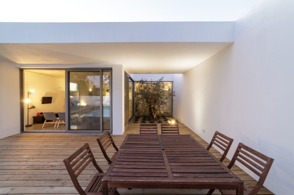 Modern house with garden swimming pool and wooden deck