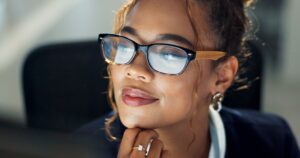 Thinking, business and woman on computer in office for ideas of feedback, planning and project prop