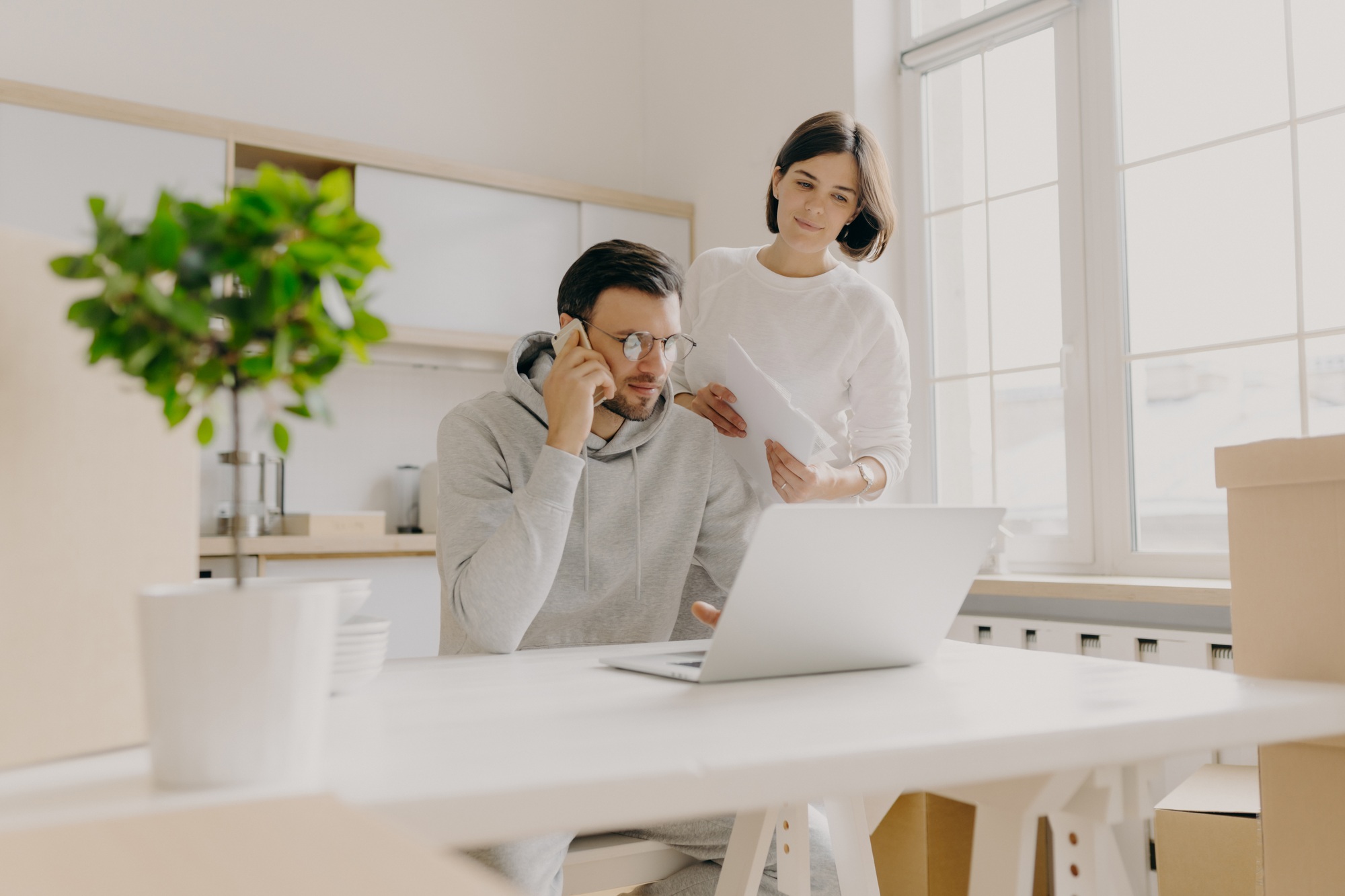 Male model searches information on laptop computer, searches new flat for rent