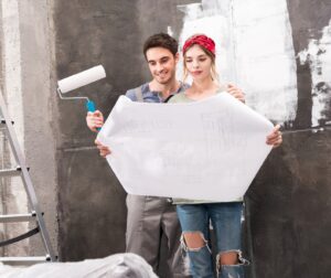 young couple looking at schemes while renovation home