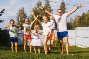 Happy large family with children in garden.