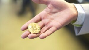 Businessman hold golden Bit coin Ticker Symbol BTC, finance money bitcoin concept. Stock. Bitcoin