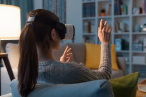 Woman relaxing on the sofa and interacting with virtual reality